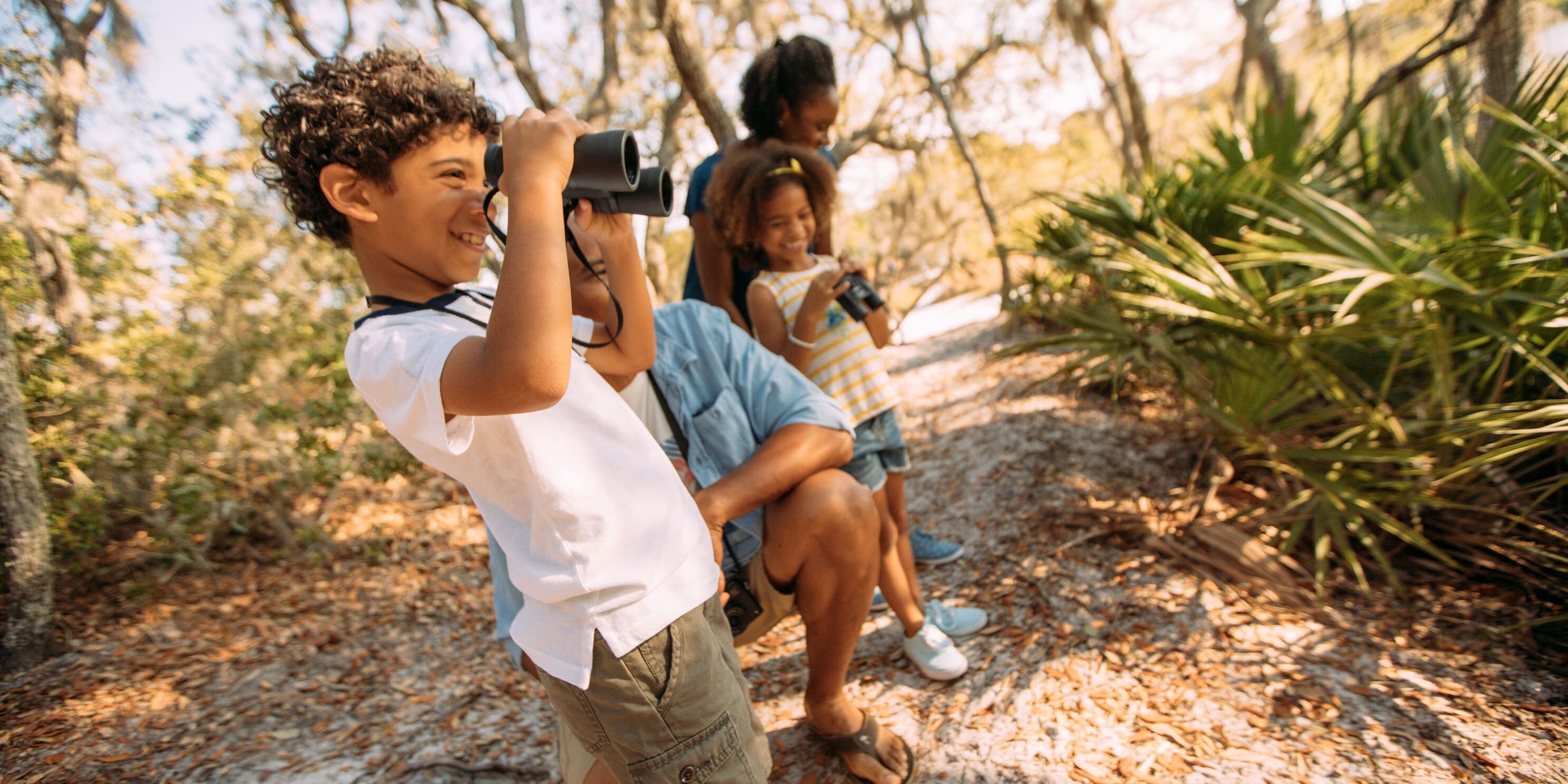 Family exploring a wooded nature trail in Bay County, Florida