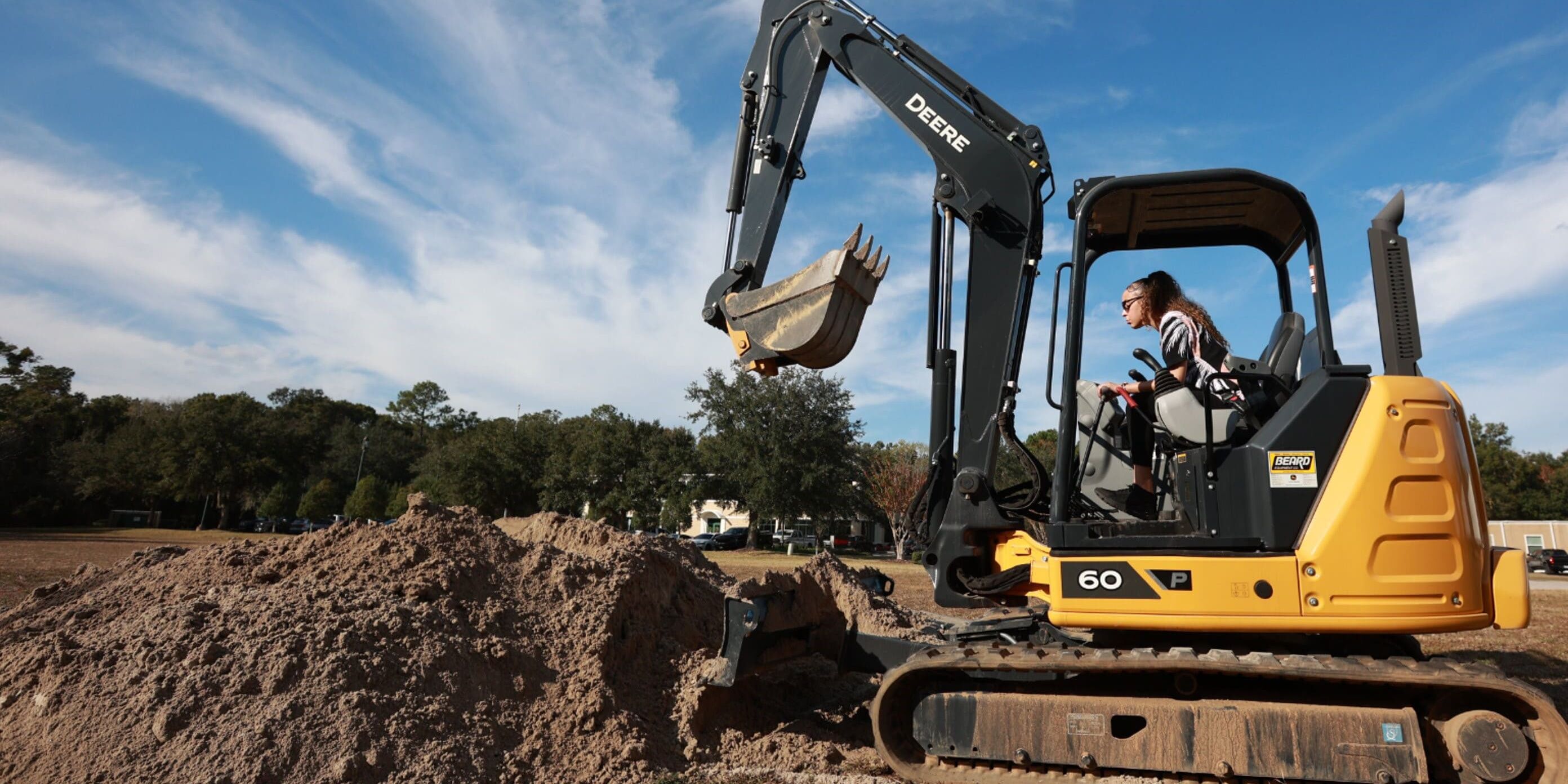 Trainee operating an excavator during transportation workforce training