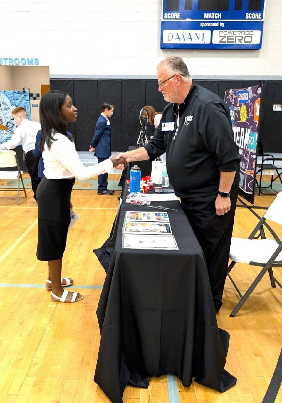 Haven Schools student shaking hands with a community professional during the Amazing Shake competition